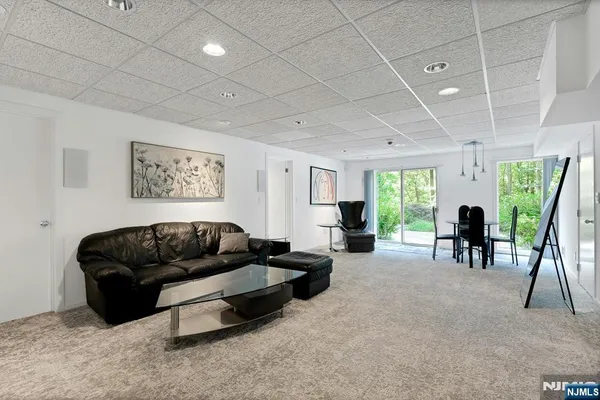 a living room with furniture rug and a table