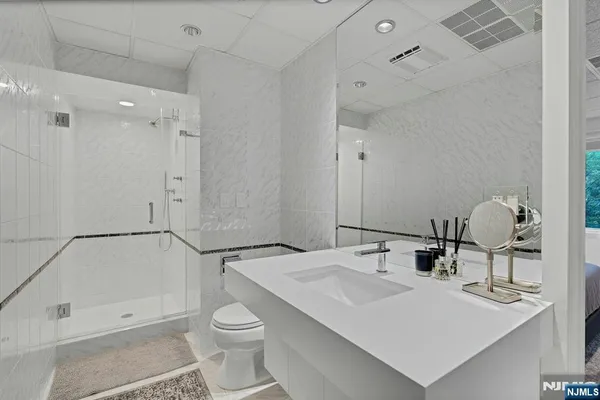 a bathroom with a sink toilet and shower