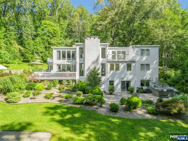 a aerial view of a house with a yard table and chairs