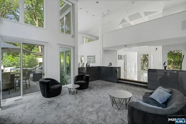 a living room with furniture a window and a potted plant