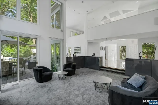 a living room with furniture a window and a potted plant