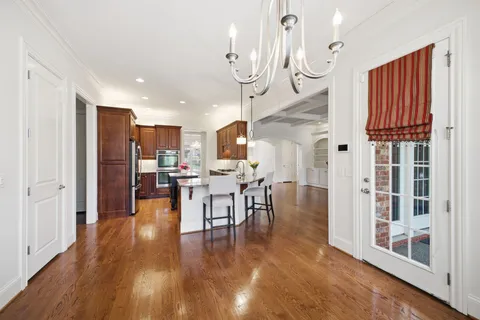 a bathroom with a granite countertop sink a toilet and shower