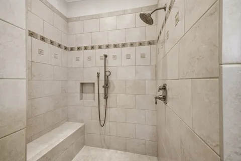 a bathroom with double vanity sinks and a mirror