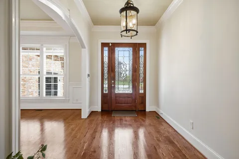 a view of empty room with wooden floor and fireplace