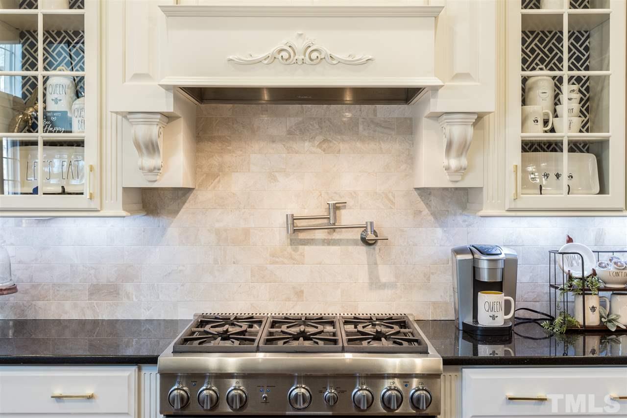 6020 Valencia Court Raleigh, NC 27614 - Photo 11 of 29 a stove top oven sitting inside of a kitchen