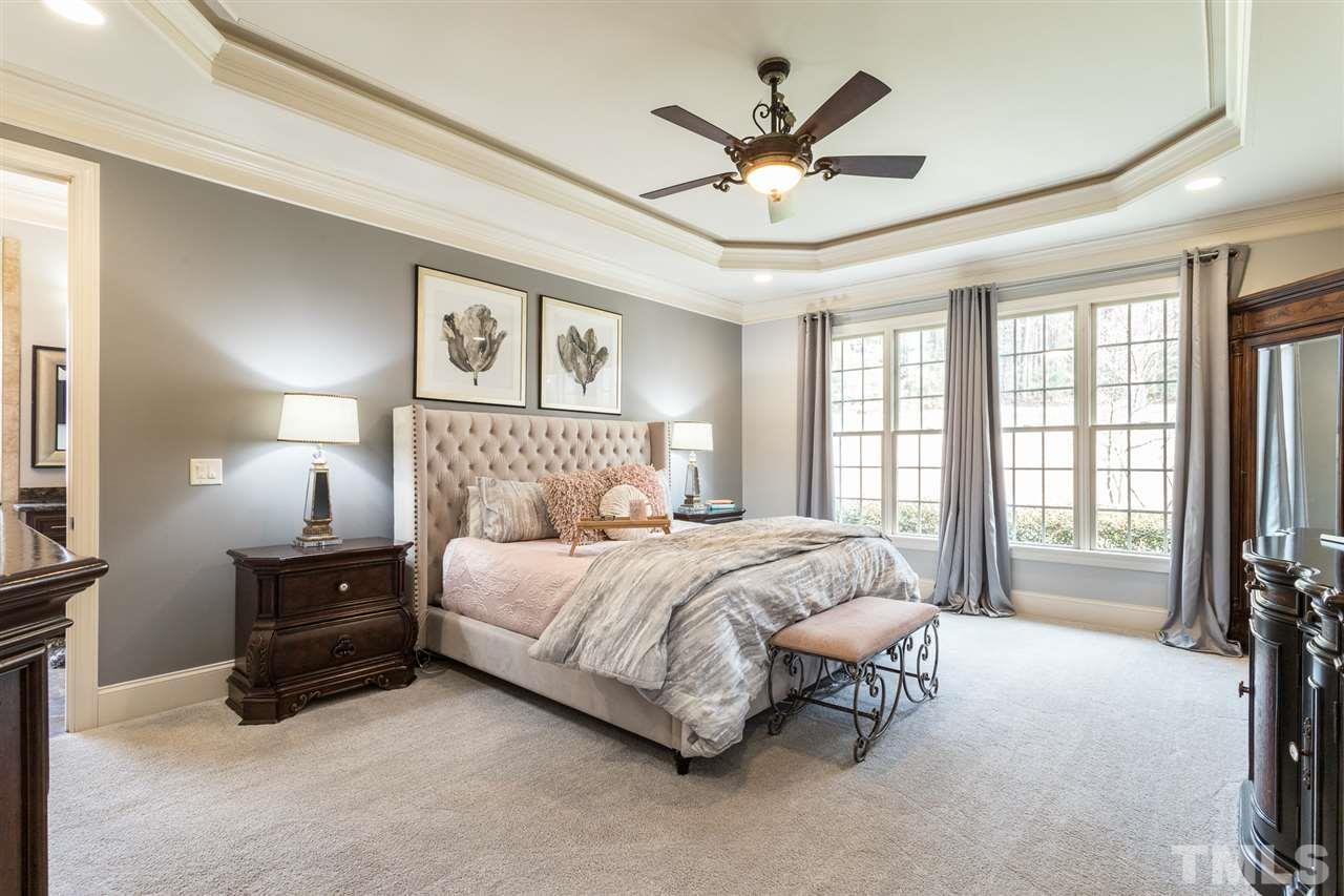 6020 Valencia Court Raleigh, NC 27614 - Photo 12 of 29 a bedroom with a large bed and a chandelier