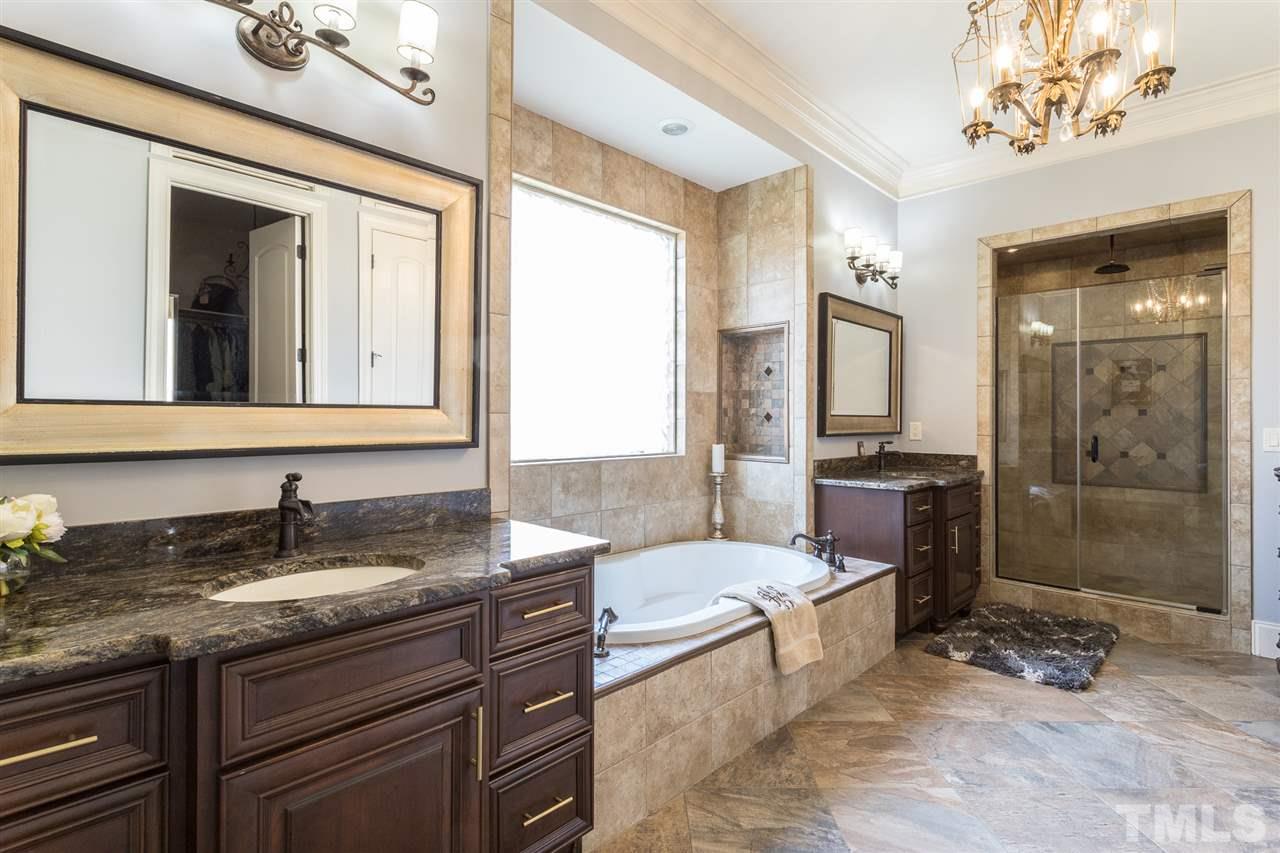 6020 Valencia Court Raleigh, NC 27614 - Photo 13 of 29 a spacious bathroom with a granite countertop sink a mirror and a shower