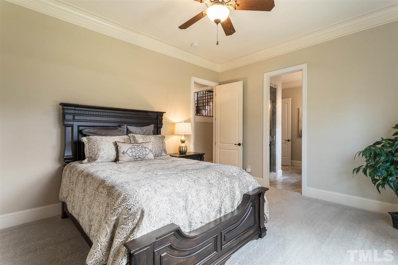 6020 Valencia Court Raleigh, NC 27614 - Photo 15 of 29 a bedroom with a bed and a potted plant