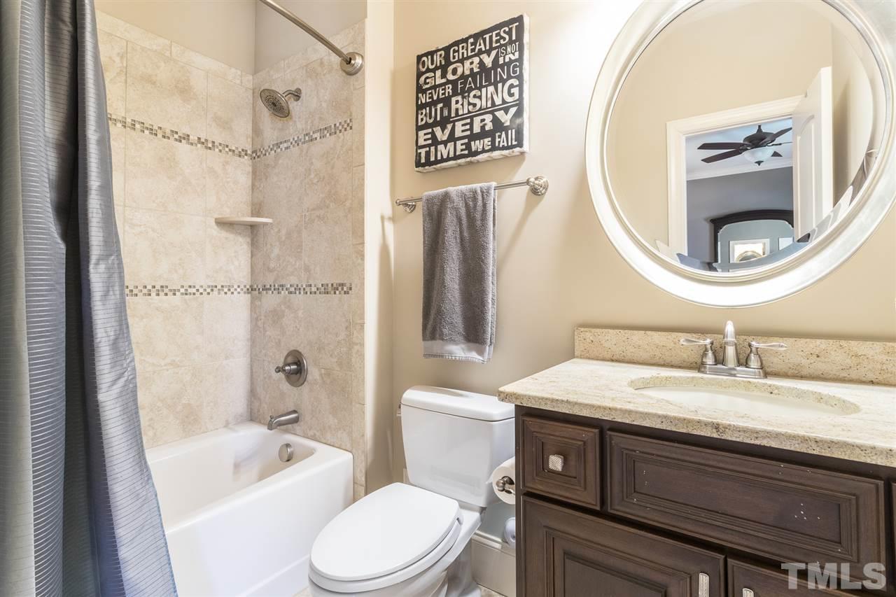 6020 Valencia Court Raleigh, NC 27614 - Photo 17 of 29 a bathroom with a sink a toilet and a mirror