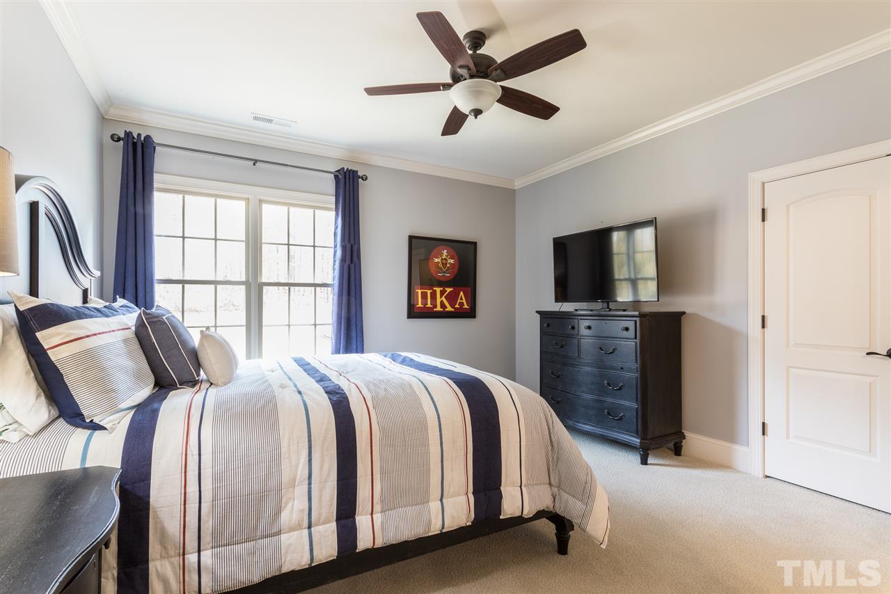 6020 Valencia Court Raleigh, NC 27614 - Photo 20 of 29 a spacious bedroom with a bed and a flat screen tv