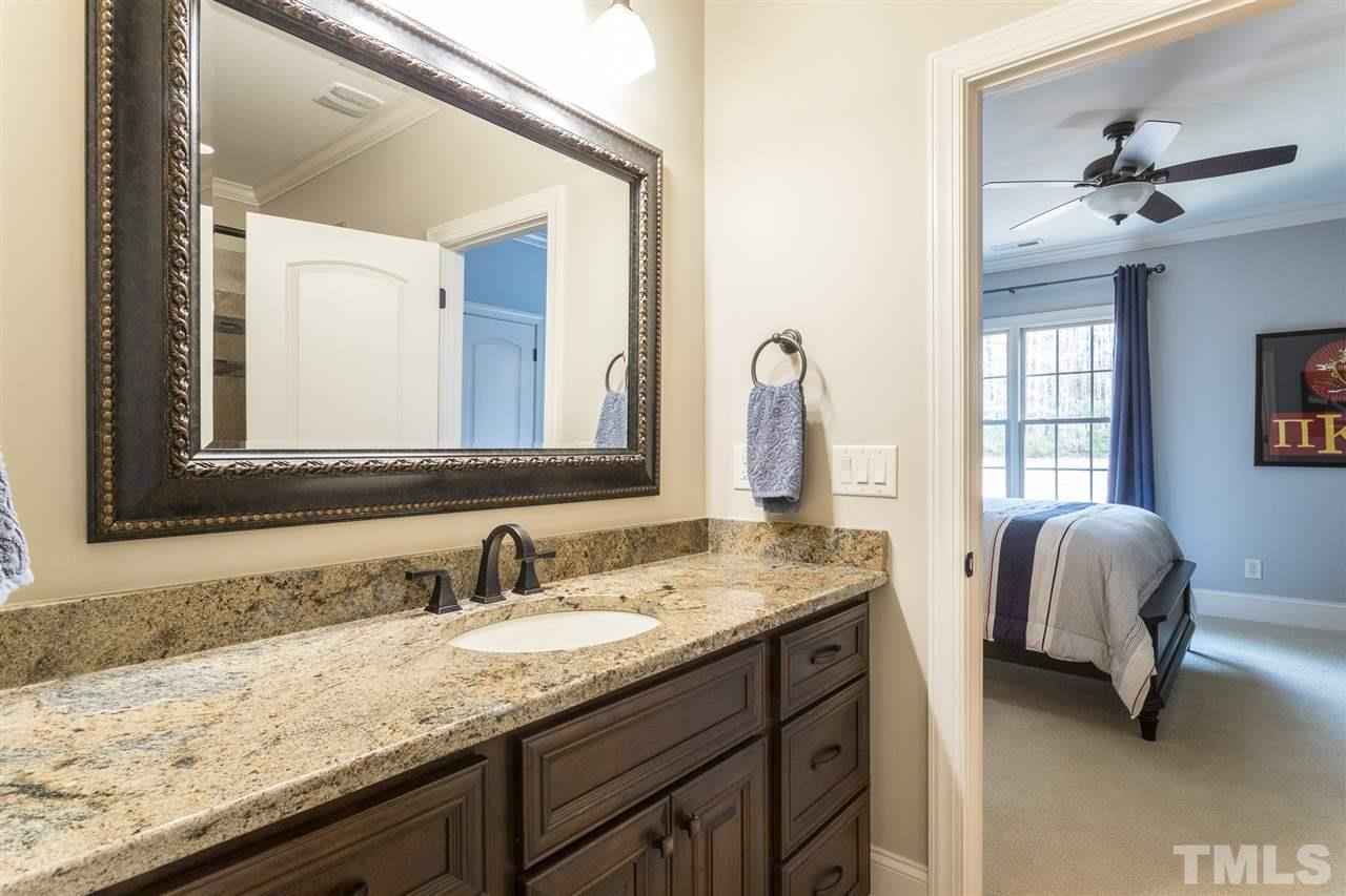 6020 Valencia Court Raleigh, NC 27614 - Photo 21 of 29 a en suite bathroom with a granite countertop double vanity sinks and a mirror