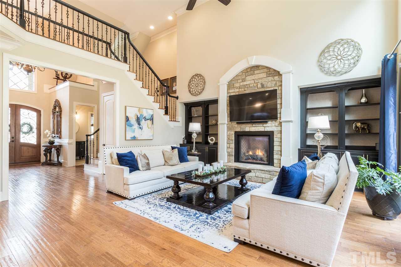 6020 Valencia Court Raleigh, NC 27614 - Photo 6 of 29 a living room with furniture a fireplace and a chandelier