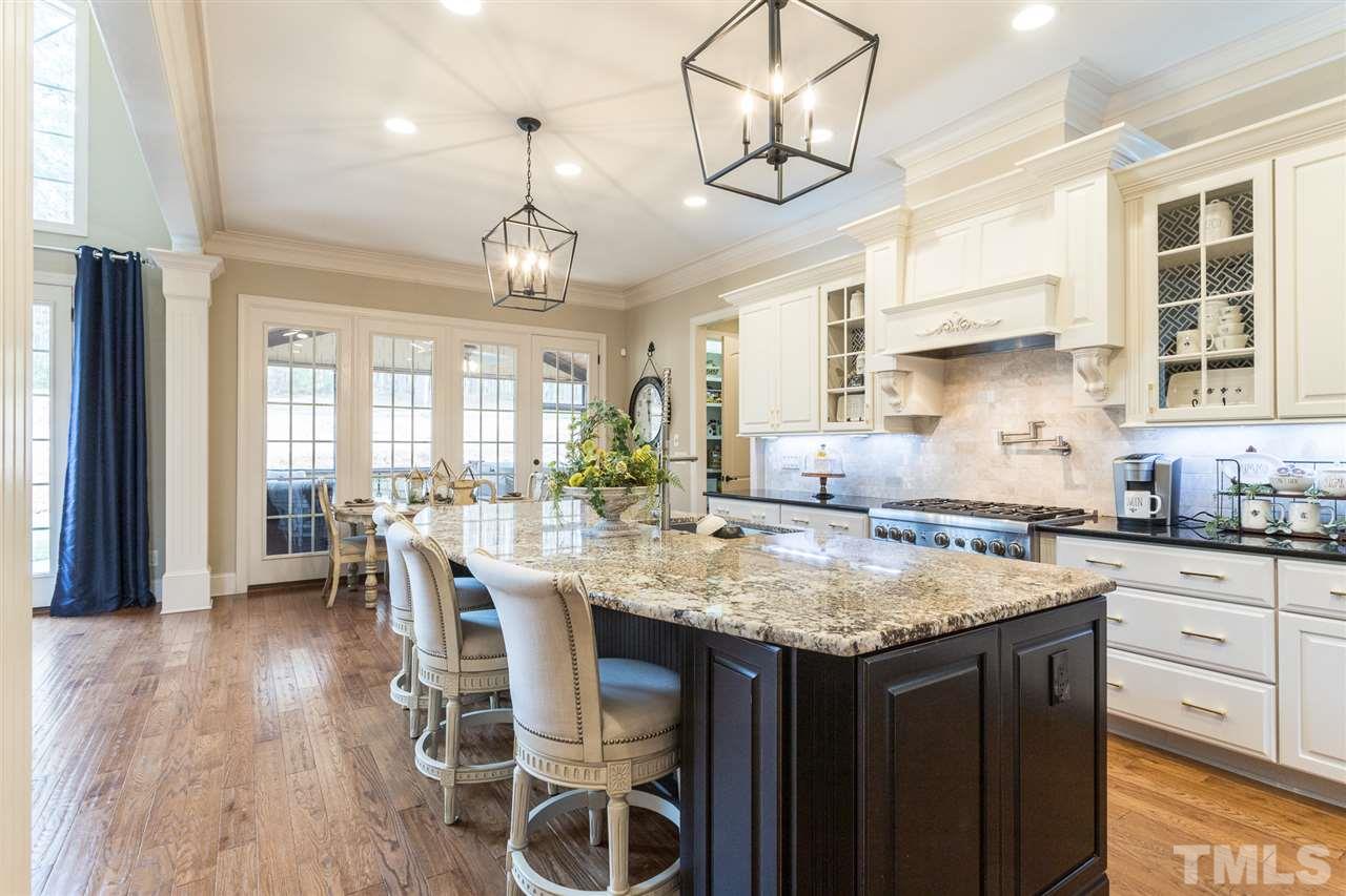 6020 Valencia Court Raleigh, NC 27614 - Photo 9 of 29 a kitchen with a table chairs and wooden floor