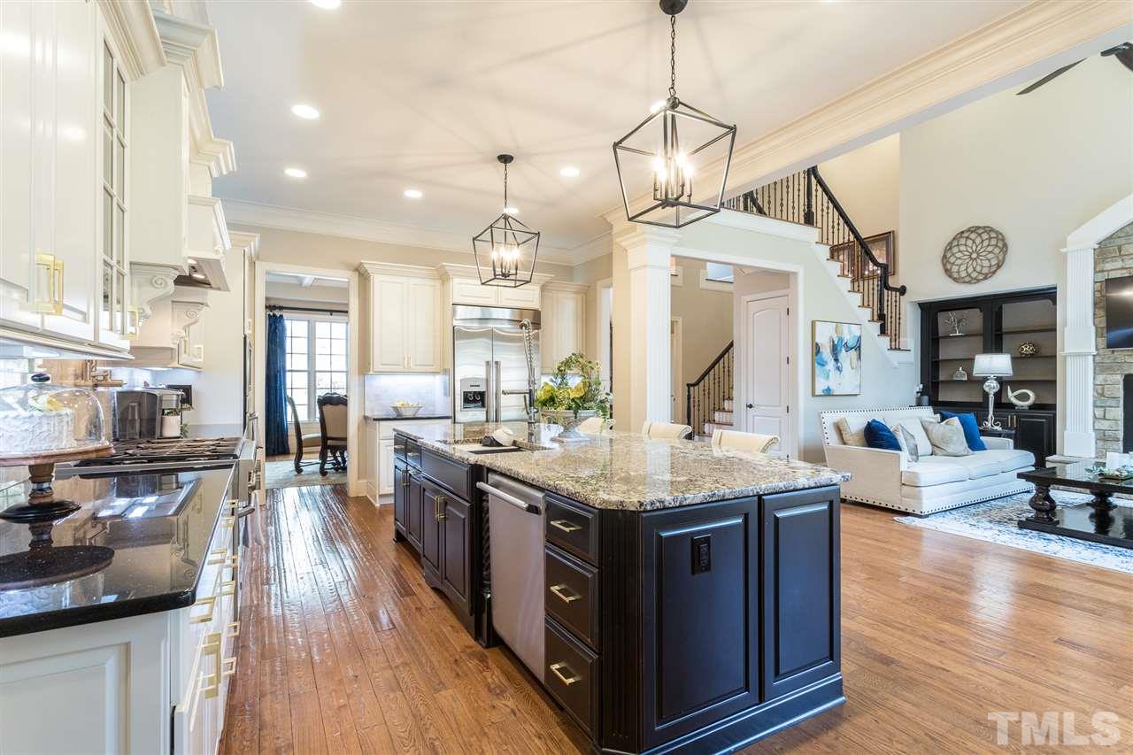 6020 Valencia Court Raleigh, NC 27614 - Photo 10 of 29 a kitchen with stainless steel appliances granite countertop a sink stove and wooden floor