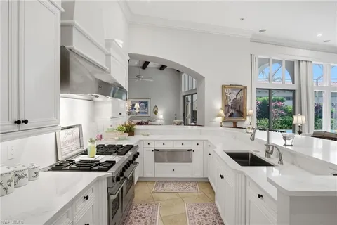 a kitchen with stainless steel appliances a sink stove and cabinets