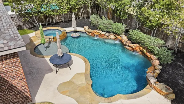 a view of a swimming pool with a yard