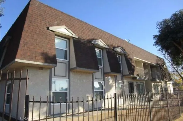 a view of a house with brick walls