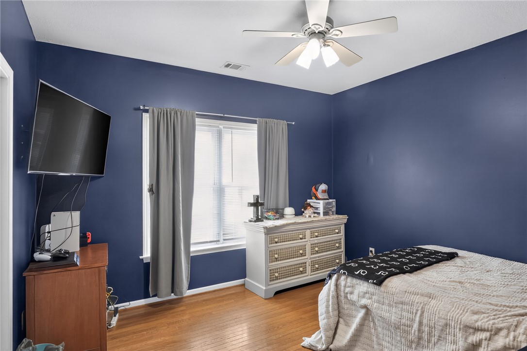 144 Elliott Circle Anderson, SC 29621 - Photo 16 of 30 Hardwood floors and a ceiling fan enhance this naturally illuminated bedroom.