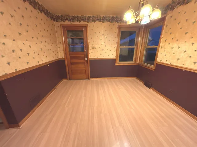 a view of a room with wooden floor and closet