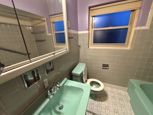 a view of a house with a backyard and a patio