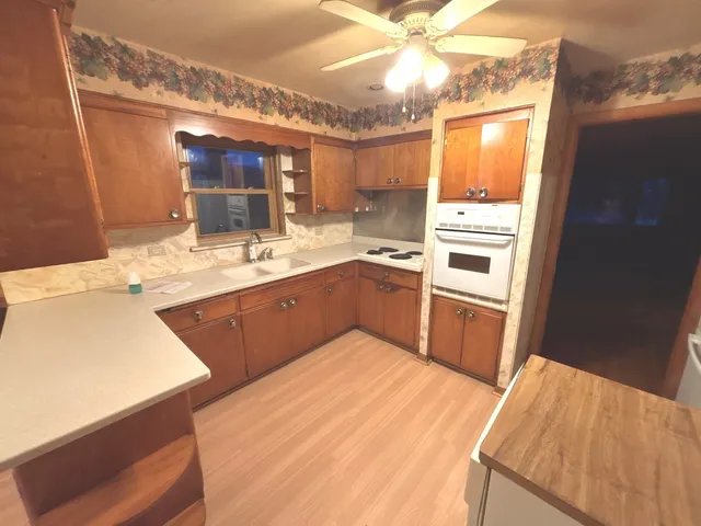 a kitchen with a sink stove and cabinets