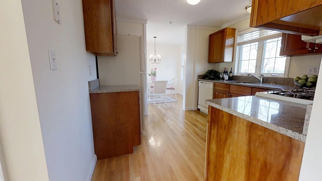 985 Trapelo Road, Unit 20 Waltham, MA 02452 - Photo 8 of 16 a kitchen with a sink and a refrigerator