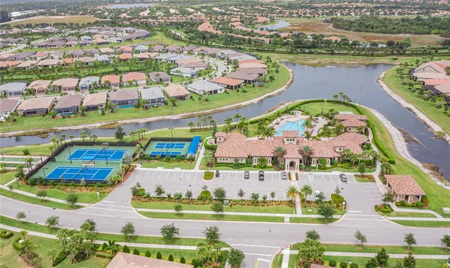 an aerial view of residential houses with outdoor space and swimming pool