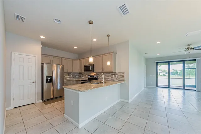 a kitchen with a refrigerator a sink and a stove top oven
