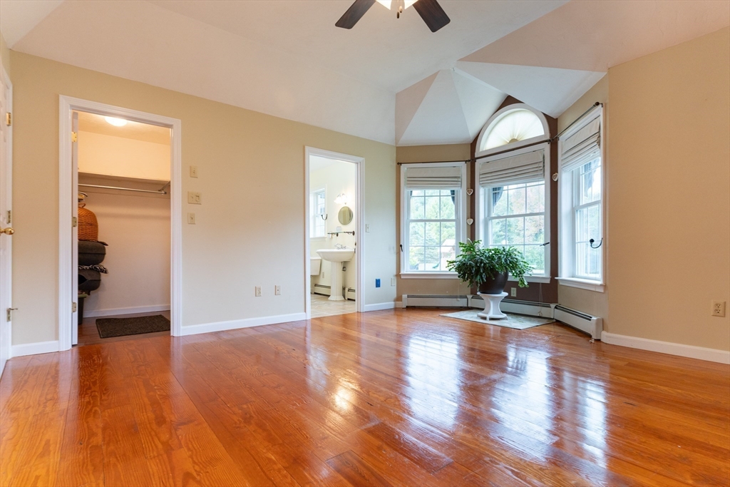 110 Hosley Road Gardner, MA 01440 - Photo 16 of 42 a view of a livingroom with wooden floor a ceiling fan and windows
