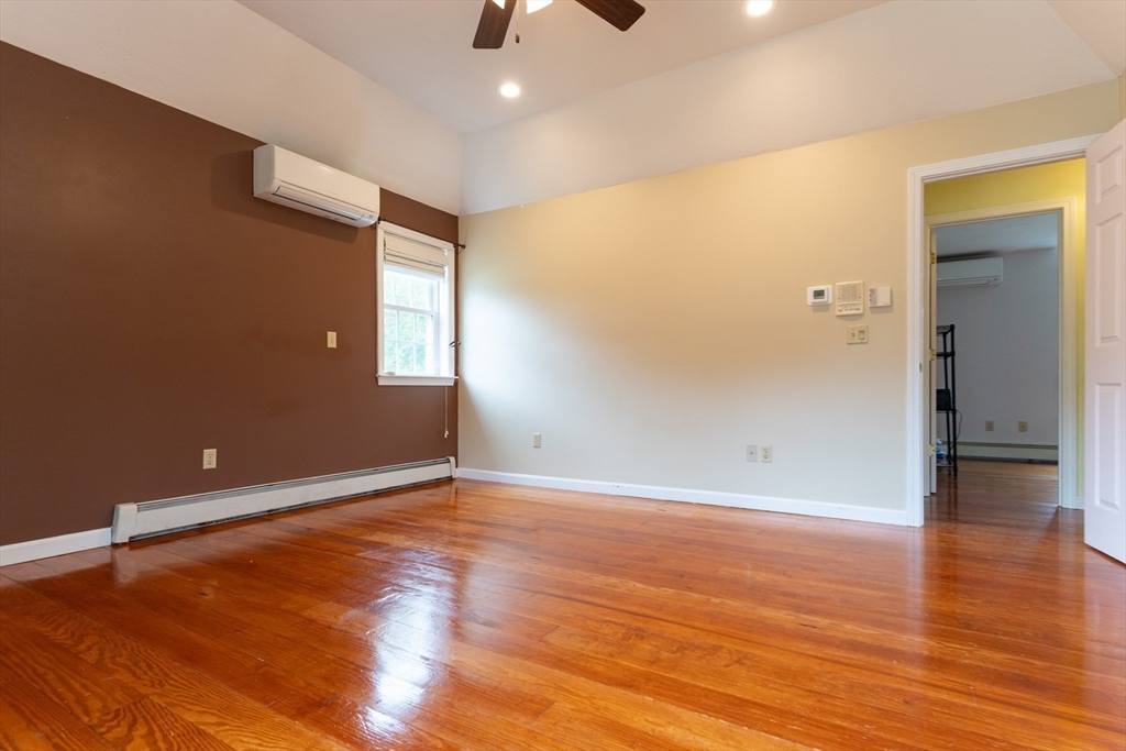 110 Hosley Road Gardner, MA 01440 - Photo 17 of 42 an empty room with wooden floor and windows
