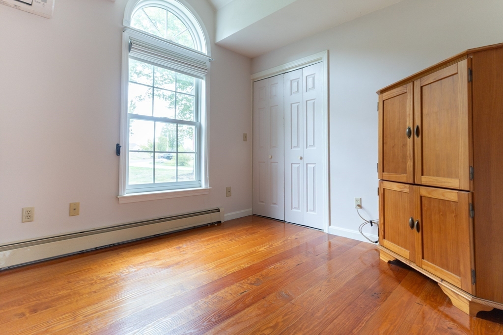 110 Hosley Road Gardner, MA 01440 - Photo 23 of 42 an empty room with wooden floor cabinet and windows
