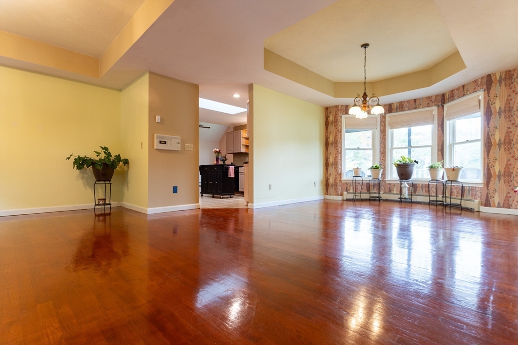 110 Hosley Road Gardner, MA 01440 - Photo 3 of 42 an empty room with wooden floor and windows