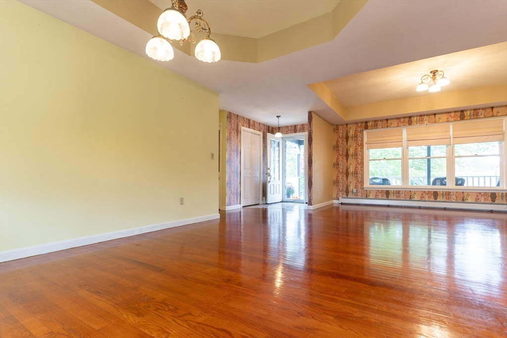 110 Hosley Road Gardner, MA 01440 - Photo 4 of 42 a view of empty room with wooden floor and fan