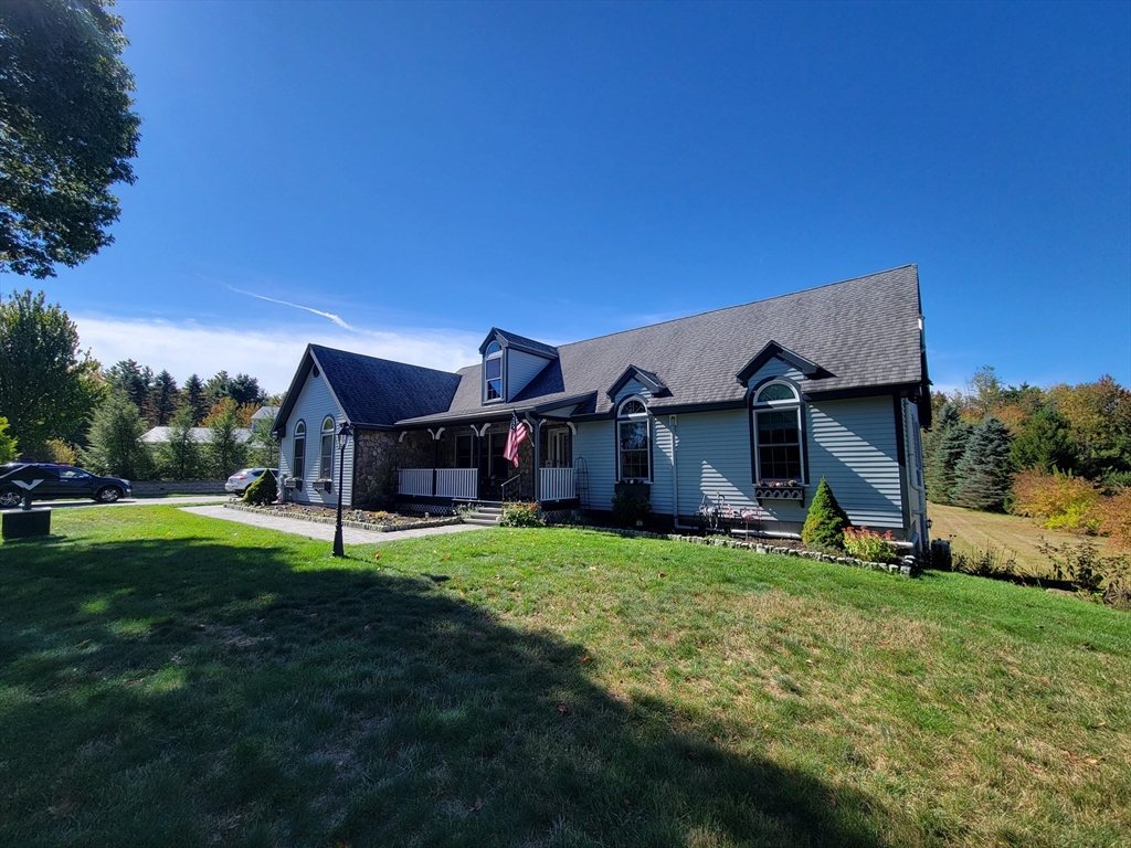 110 Hosley Road Gardner, MA 01440 - Photo 42 of 42 a house that is sitting in the grass with large trees