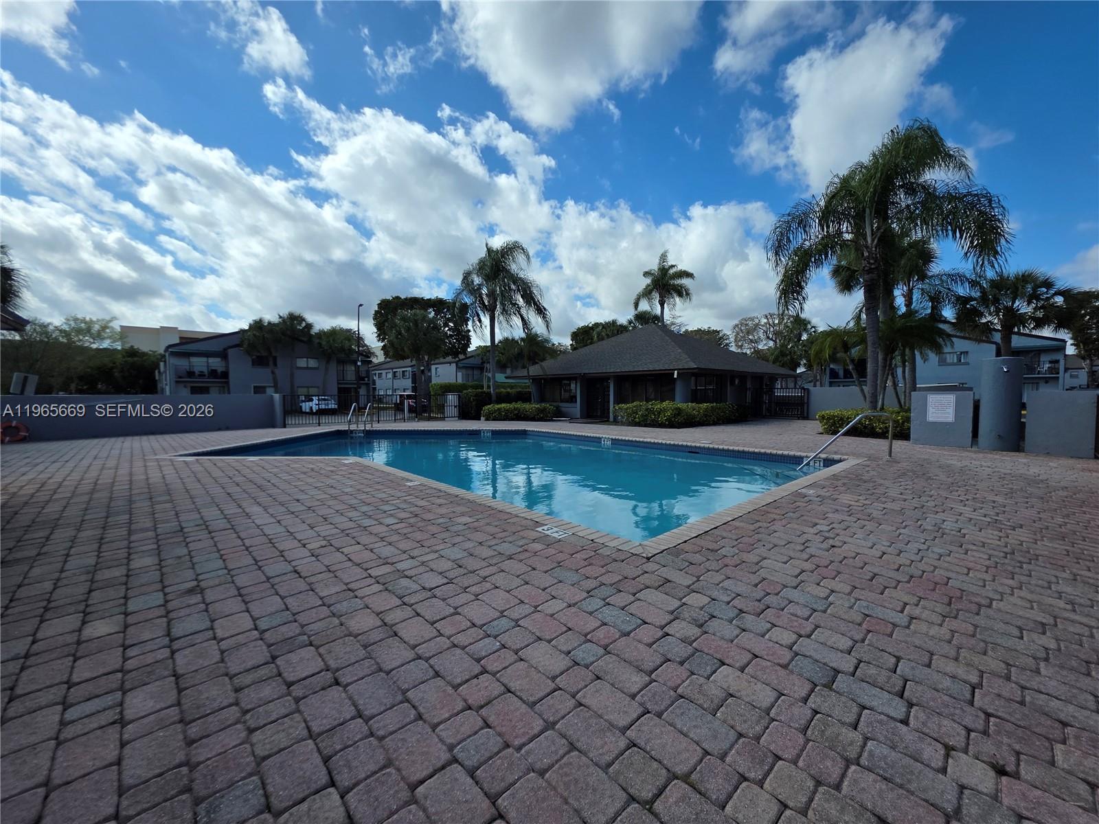 7421 Southwest 152nd Avenue, Unit 9101 Miami, FL 33193 - Photo 14 of 32 a view of a swimming pool with a yard