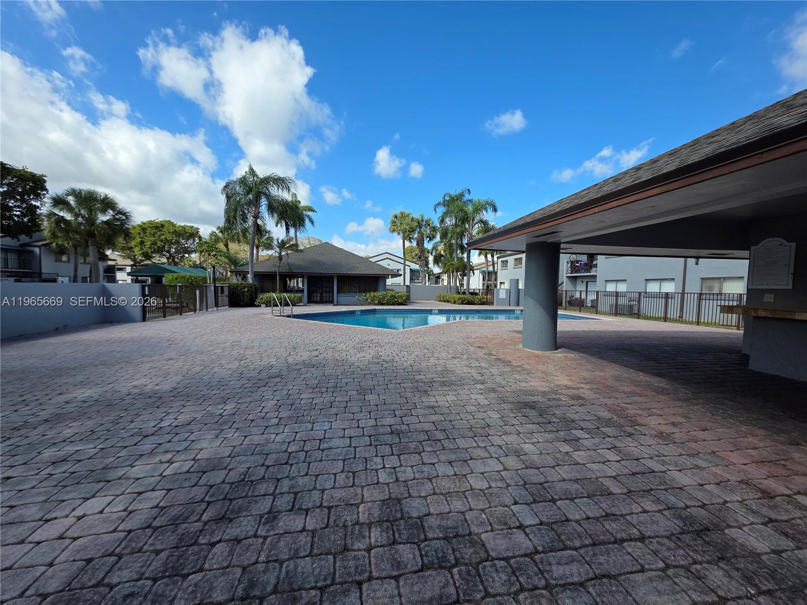 7421 Southwest 152nd Avenue, Unit 9101 Miami, FL 33193 - Photo 15 of 32 a view of a house with a yard and potted plants