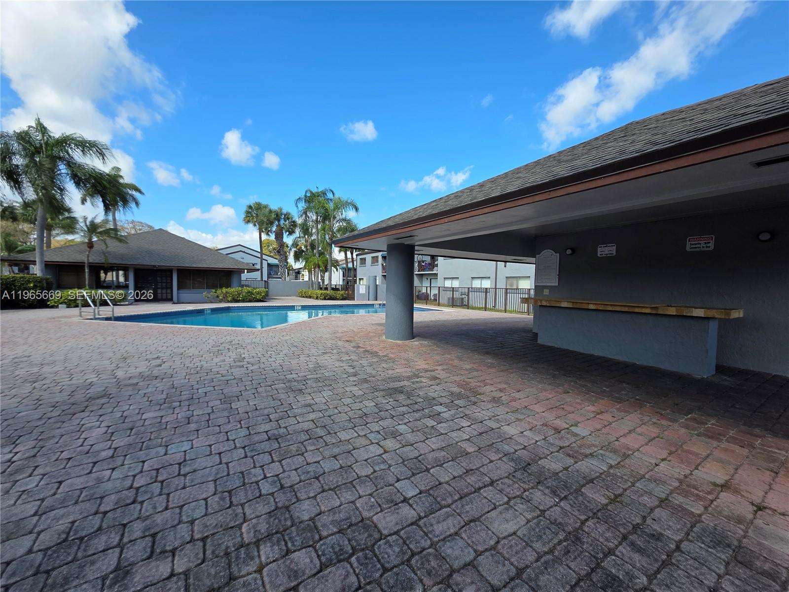 7421 Southwest 152nd Avenue, Unit 9101 Miami, FL 33193 - Photo 16 of 32 a view of a house with a yard