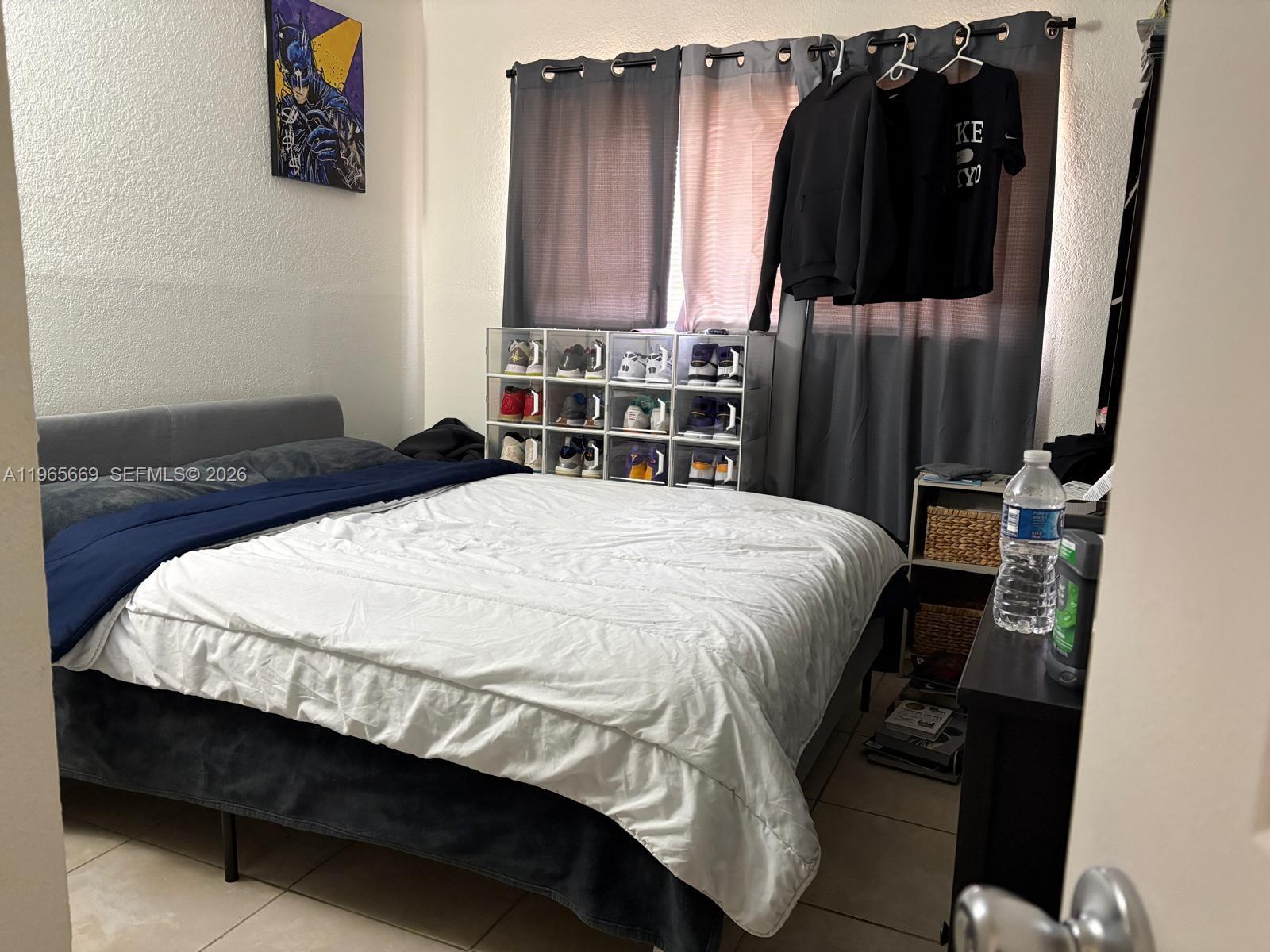 7421 Southwest 152nd Avenue, Unit 9101 Miami, FL 33193 - Photo 25 of 32 a bedroom with a bed and a closet