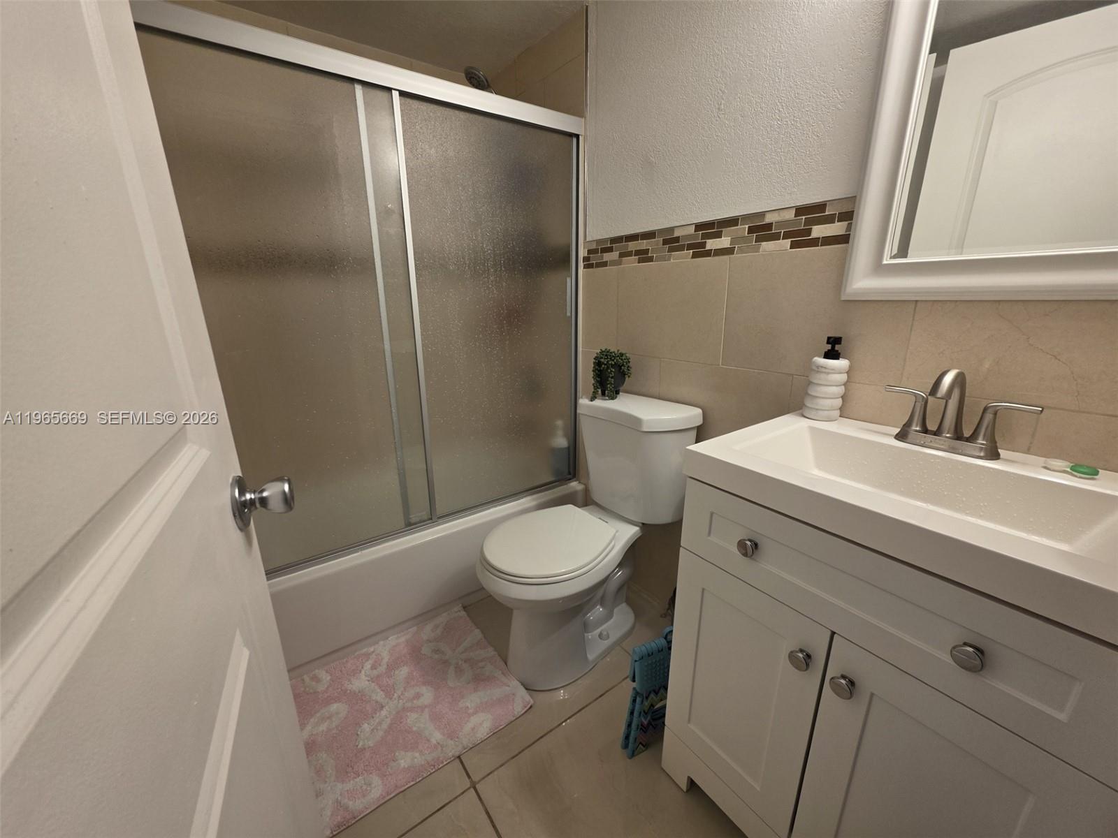 7421 Southwest 152nd Avenue, Unit 9101 Miami, FL 33193 - Photo 27 of 32 a bathroom with a toilet a sink and a shower
