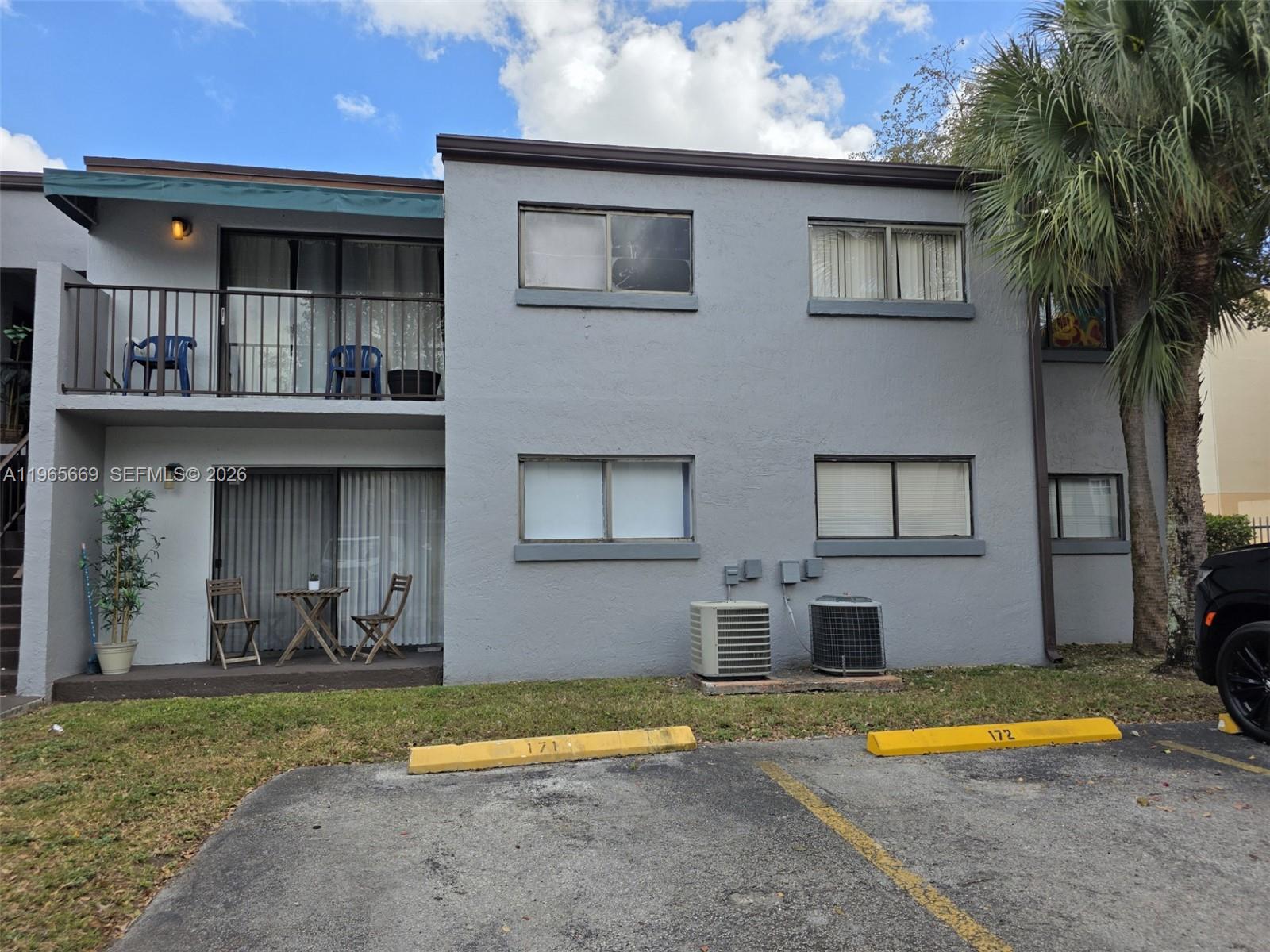 7421 Southwest 152nd Avenue, Unit 9101 Miami, FL 33193 - Photo 4 of 32 a front view of a house with a yard and garage