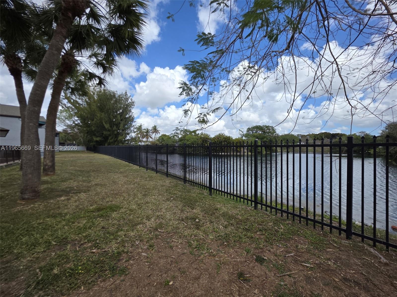 7421 Southwest 152nd Avenue, Unit 9101 Miami, FL 33193 - Photo 9 of 32 a view of backyard with wooden fence