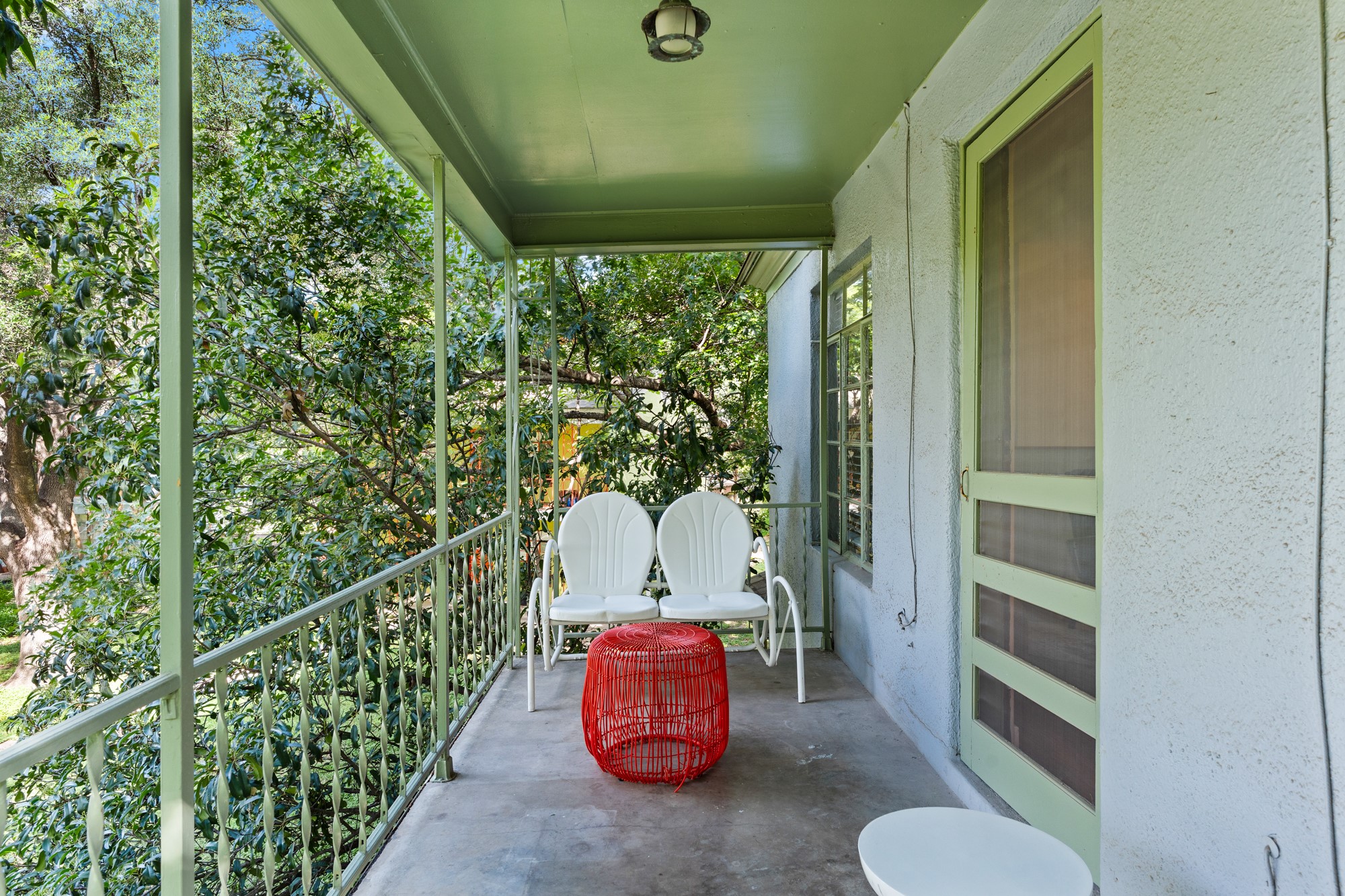 1302 Kirkwood Road, Unit B Austin, TX 78722 - Photo 20 of 21 A tranquil porch retreat with serene treetop views.