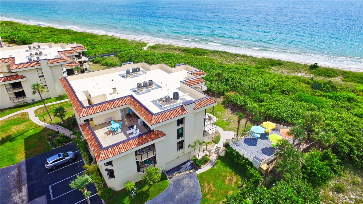 a aerial view of a house with a yard basket ball court and outdoor seating