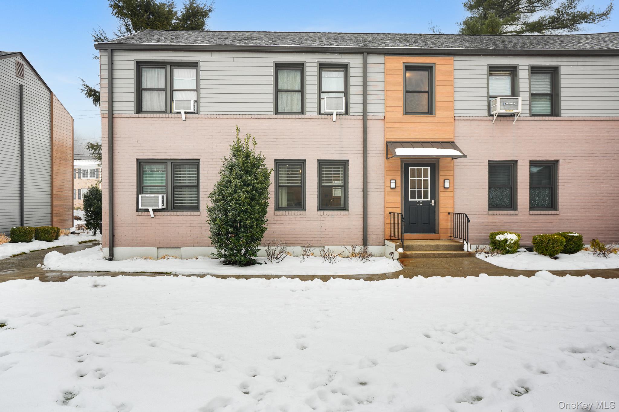 a view of a house with snow on the road