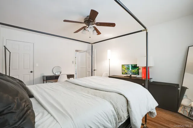 a bed room with a bed and a television