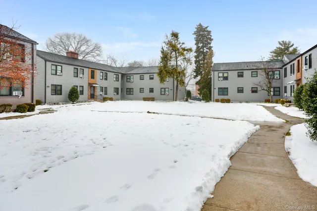 a view of a building with a snow on the road