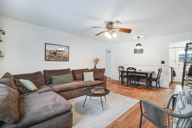 a living room with furniture a dining table and a piano