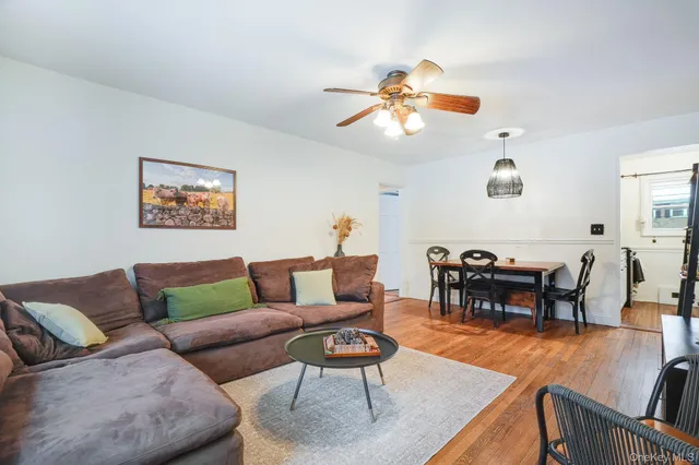 a living room with furniture kitchen view and a dining table