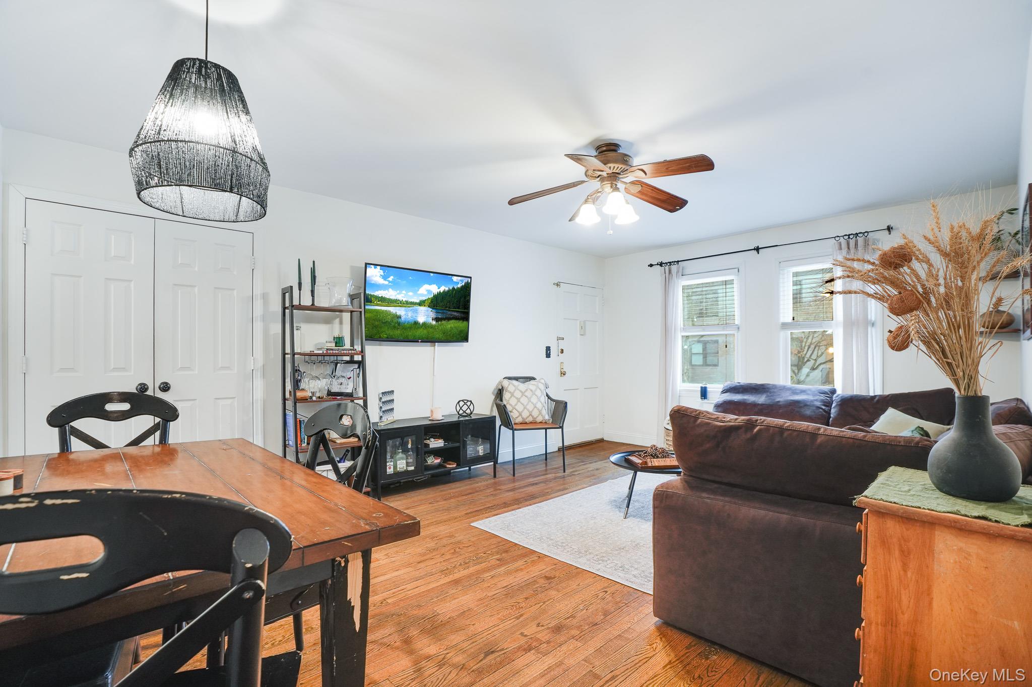10 Tappan Landing Road, Unit 53A Tarrytown, NY 10591 - Photo 9 of 20 a living room with furniture a chandelier and a flat screen tv