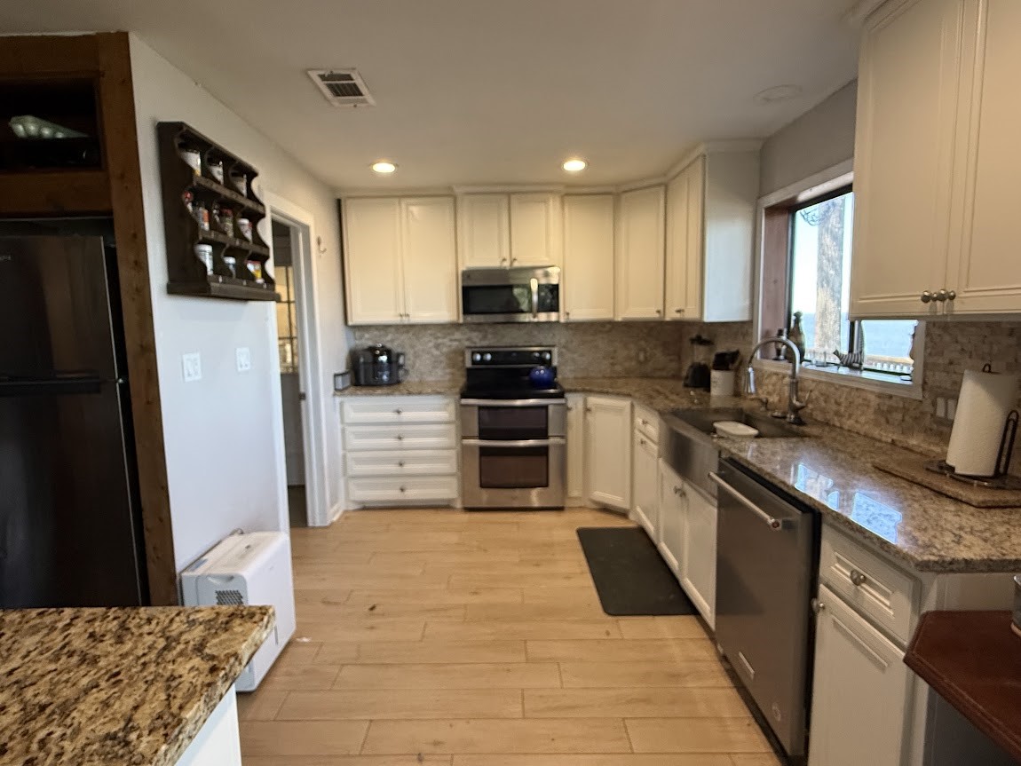 4001 East Carters Ferry Road Milam, TX 75959 - Photo 6 of 22 a kitchen with stainless steel appliances granite countertop a refrigerator a stove top oven a sink and dishwasher
